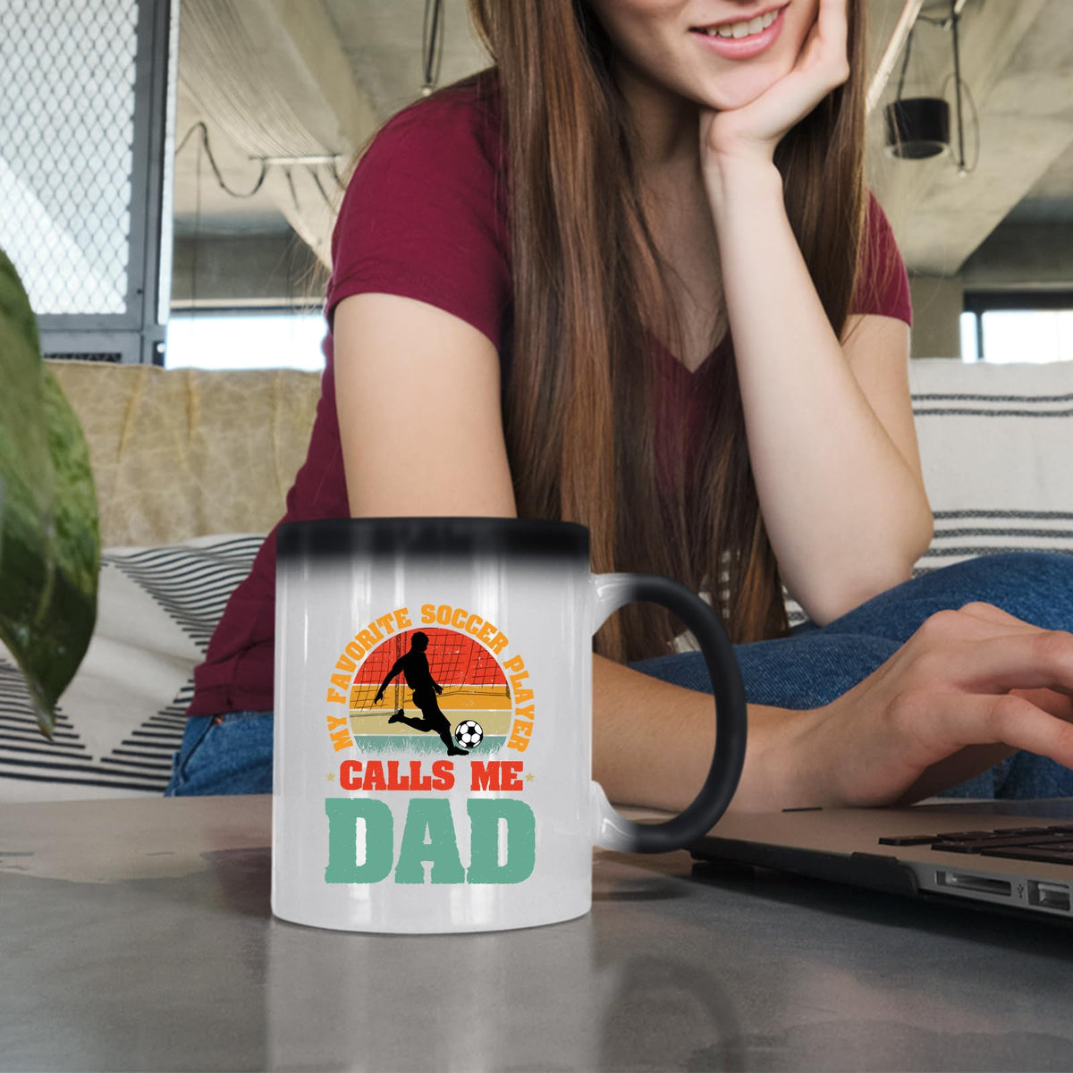 Woman at a laptop with the Soccer Dad colour changing mug
