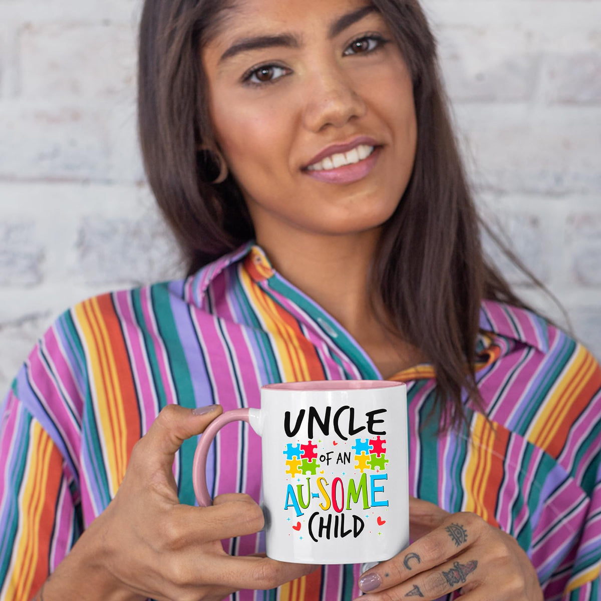 Woman in a striped shirt holding the Uncle of an Au-Some Child colour handle mug