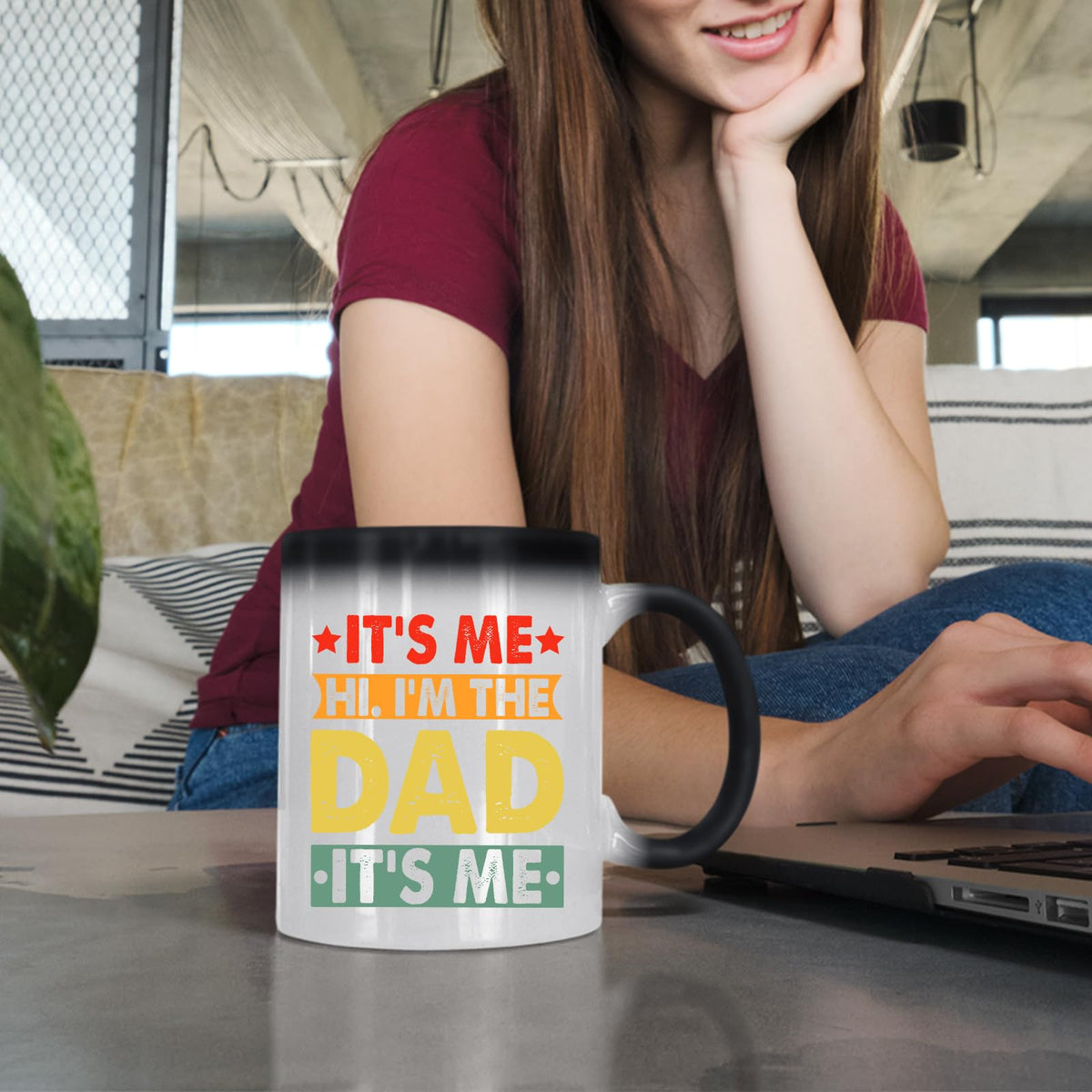 Woman at a laptop with the It’s Me Hi I’m the Dad colour changing mug