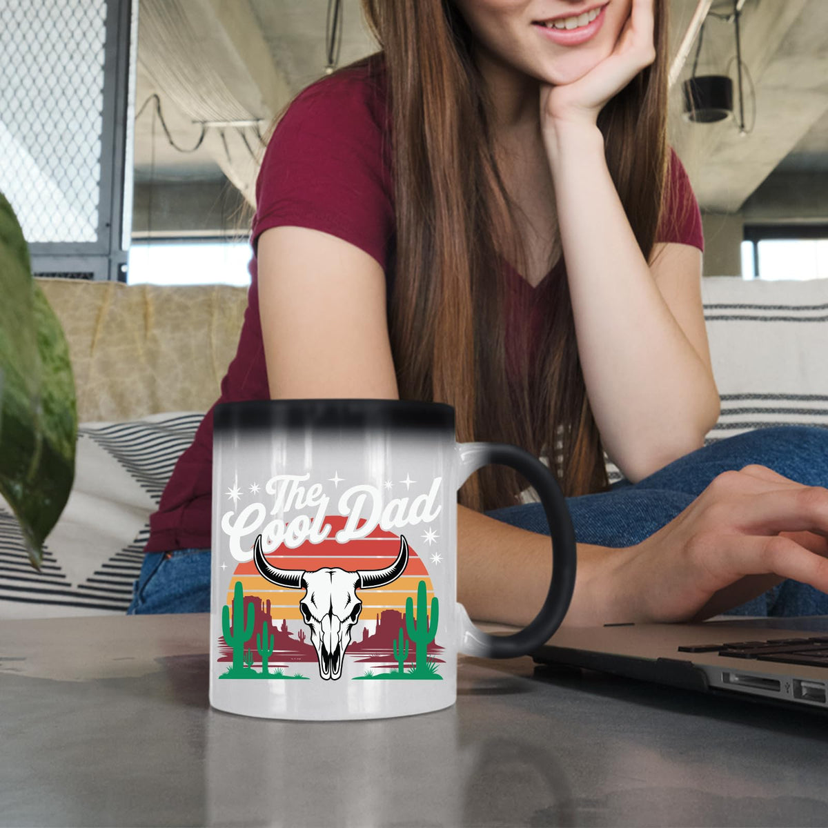 Woman at a laptop with the The Cool Dad bull skull colour changing mug