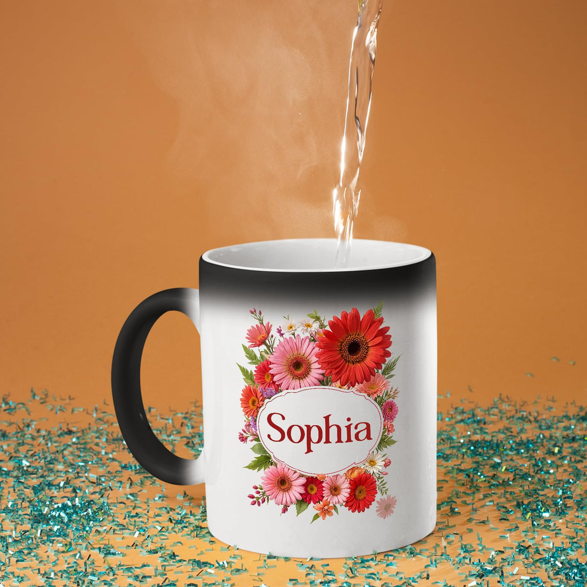 Hot water poured into the colour changing mug as a red gerbera wreath around an example name appears