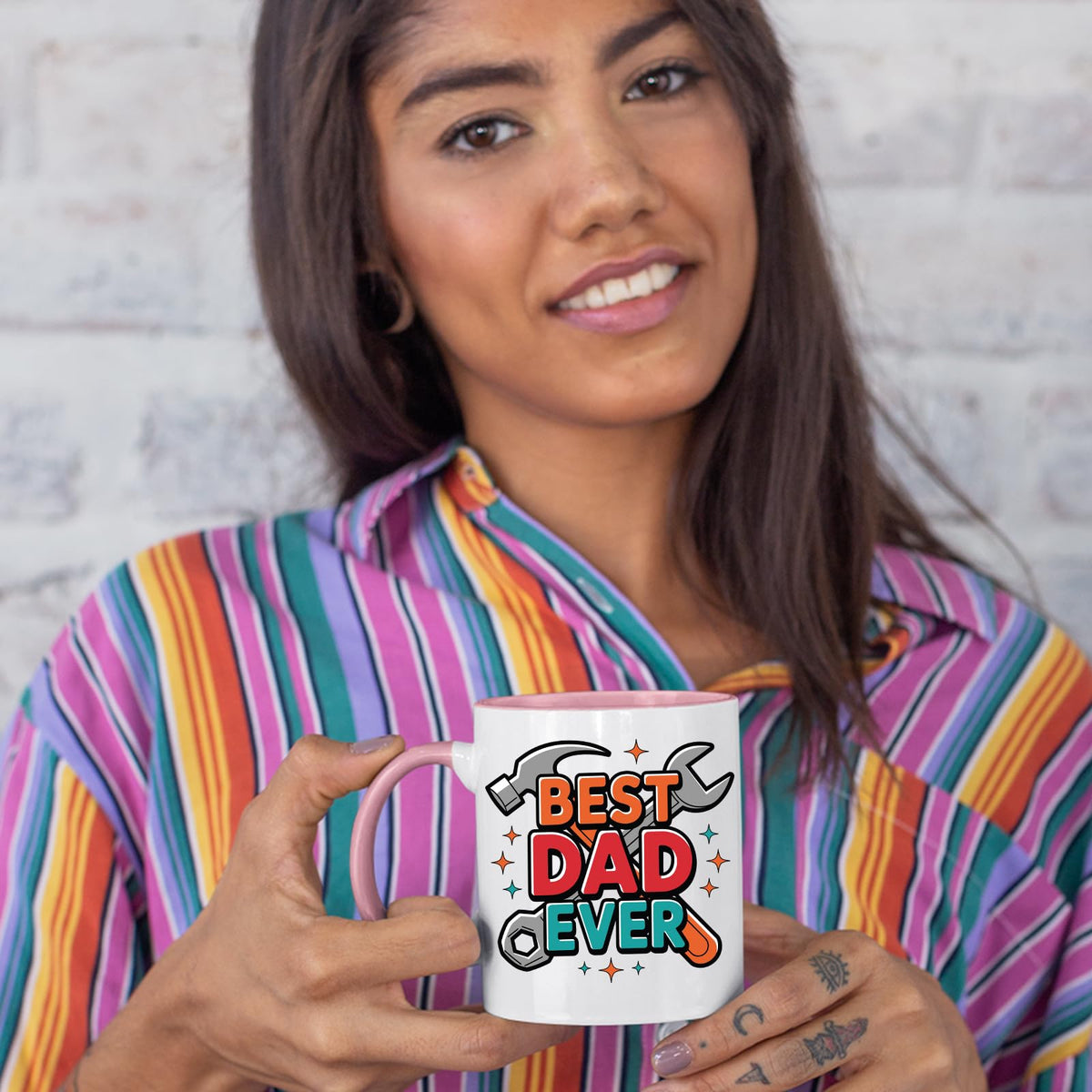 Woman in a striped shirt holding the Best Dad Ever tools colour handle mug