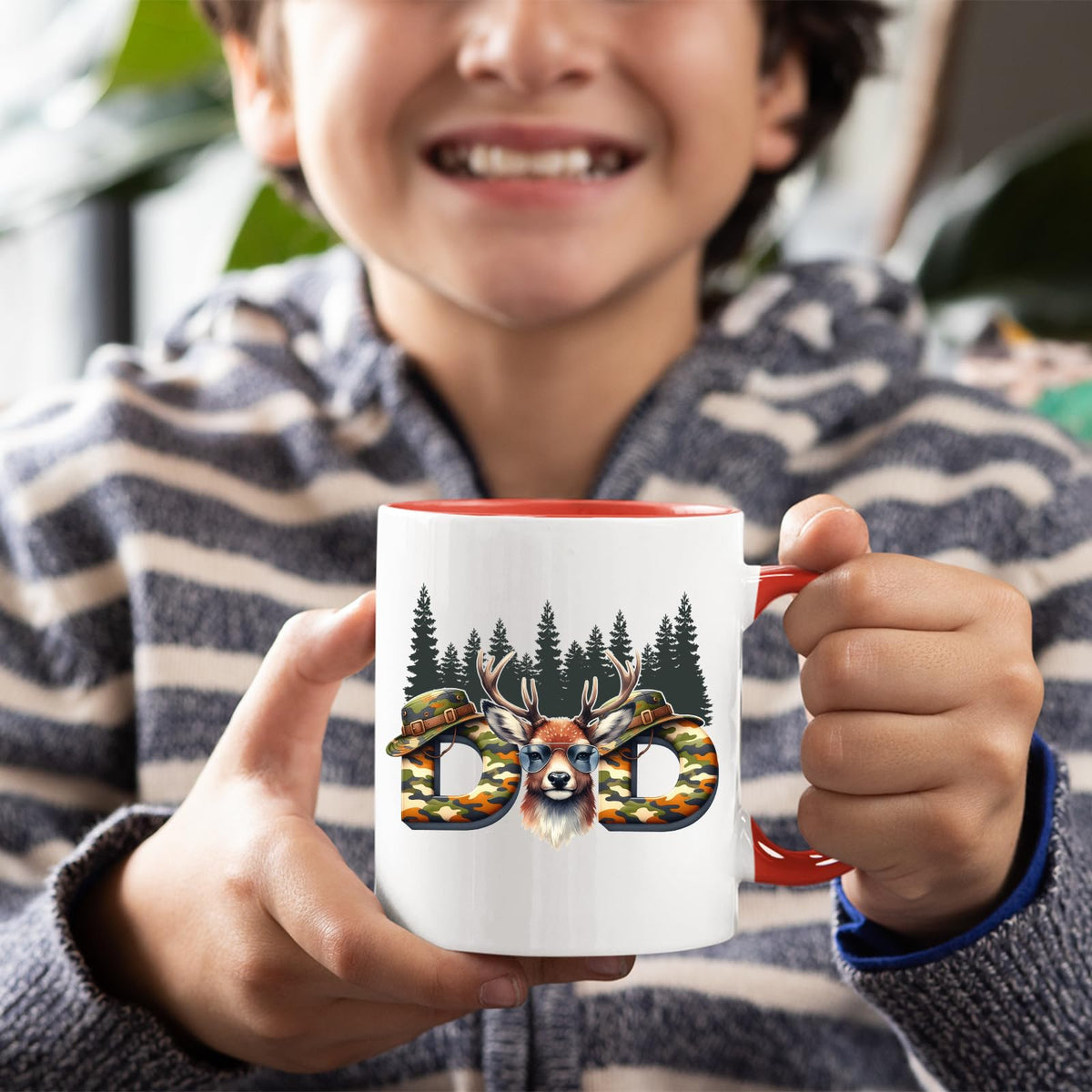 Smiling child holding the Hunting Dad deer mug with a red handle