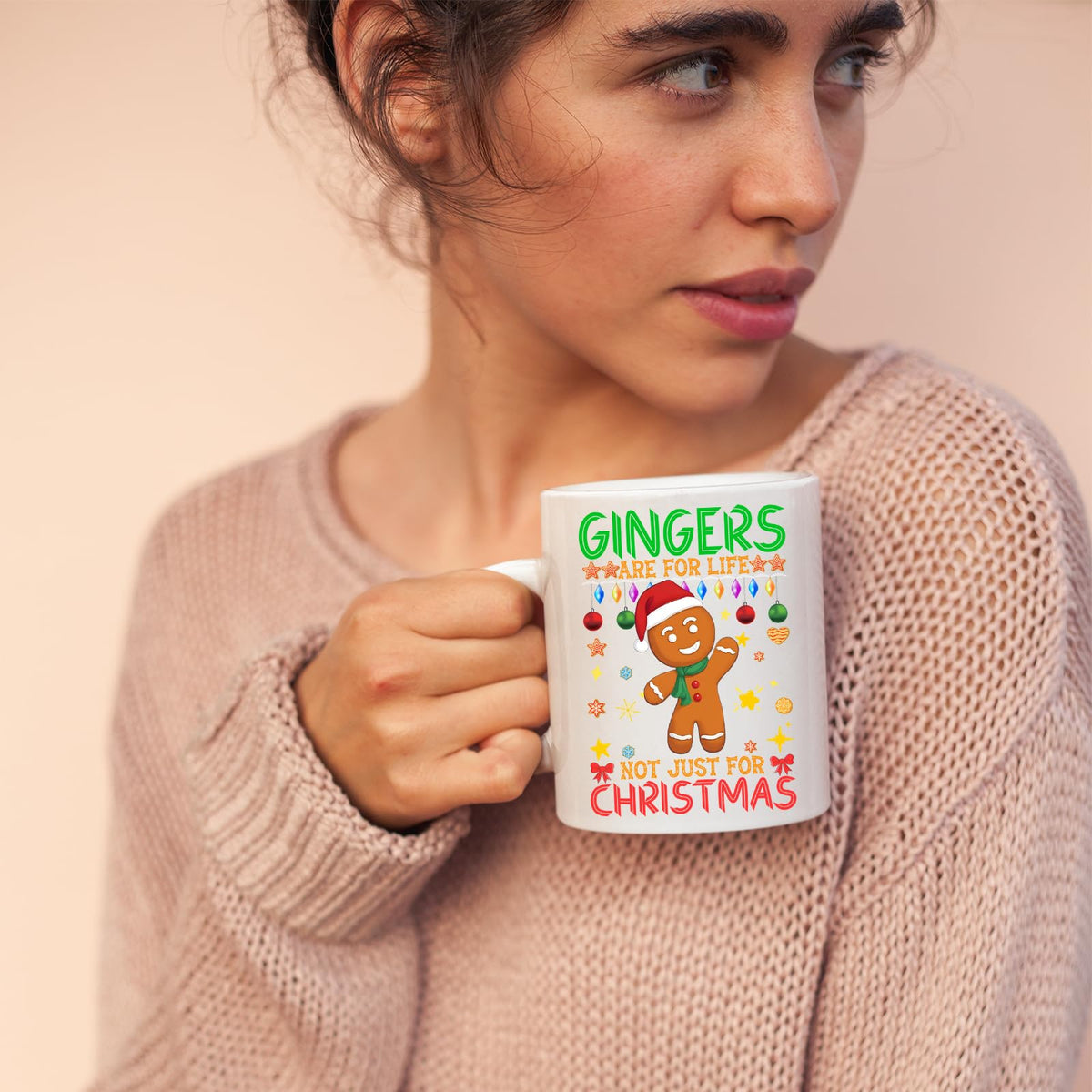 Woman in a pink jumper holding a gingers are for life mug