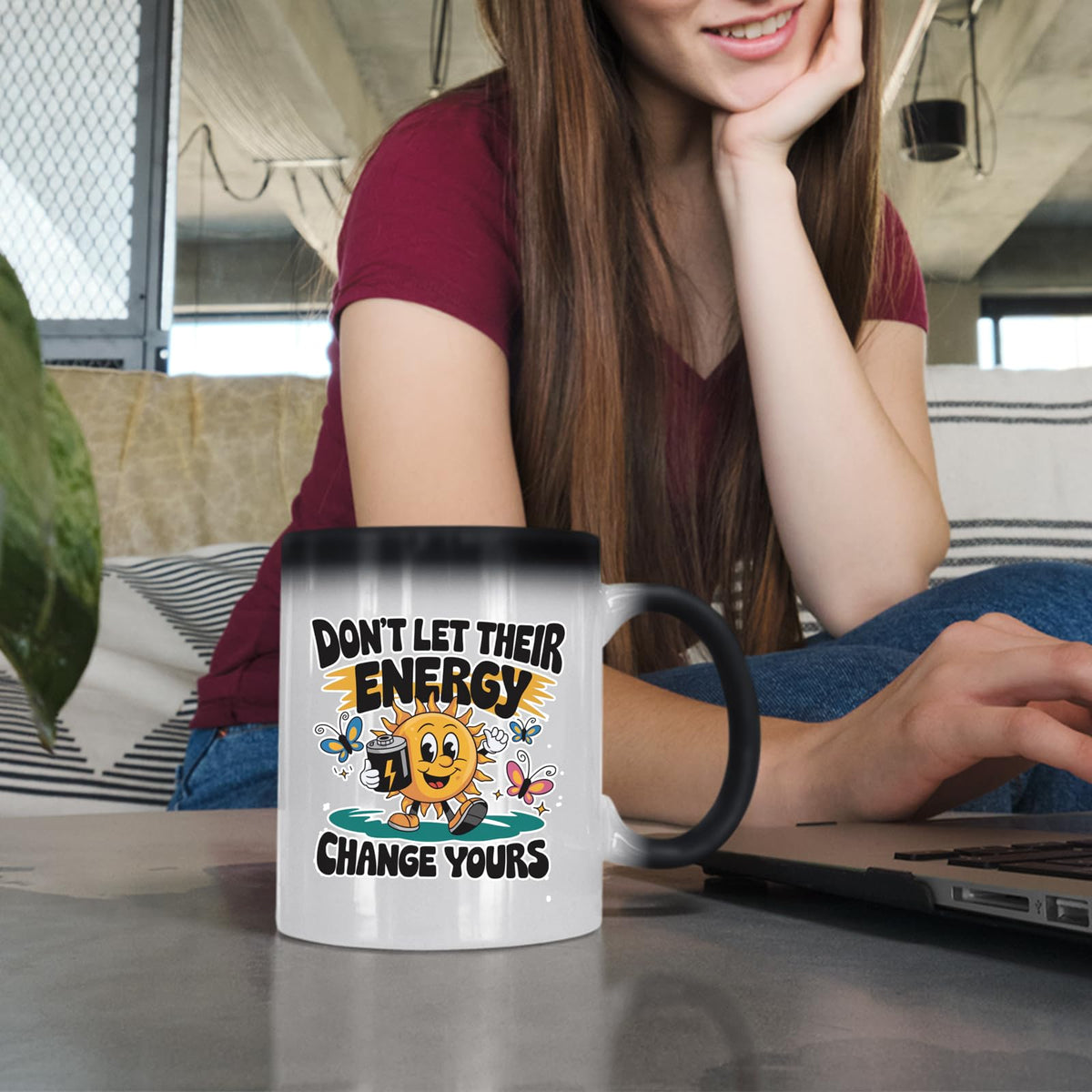 Woman at a laptop with the Positive Vibes sun colour changing mug
