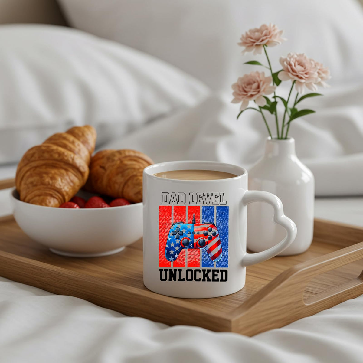 Dad Level Unlocked heart-handle mug on a breakfast tray with croissants and flowers