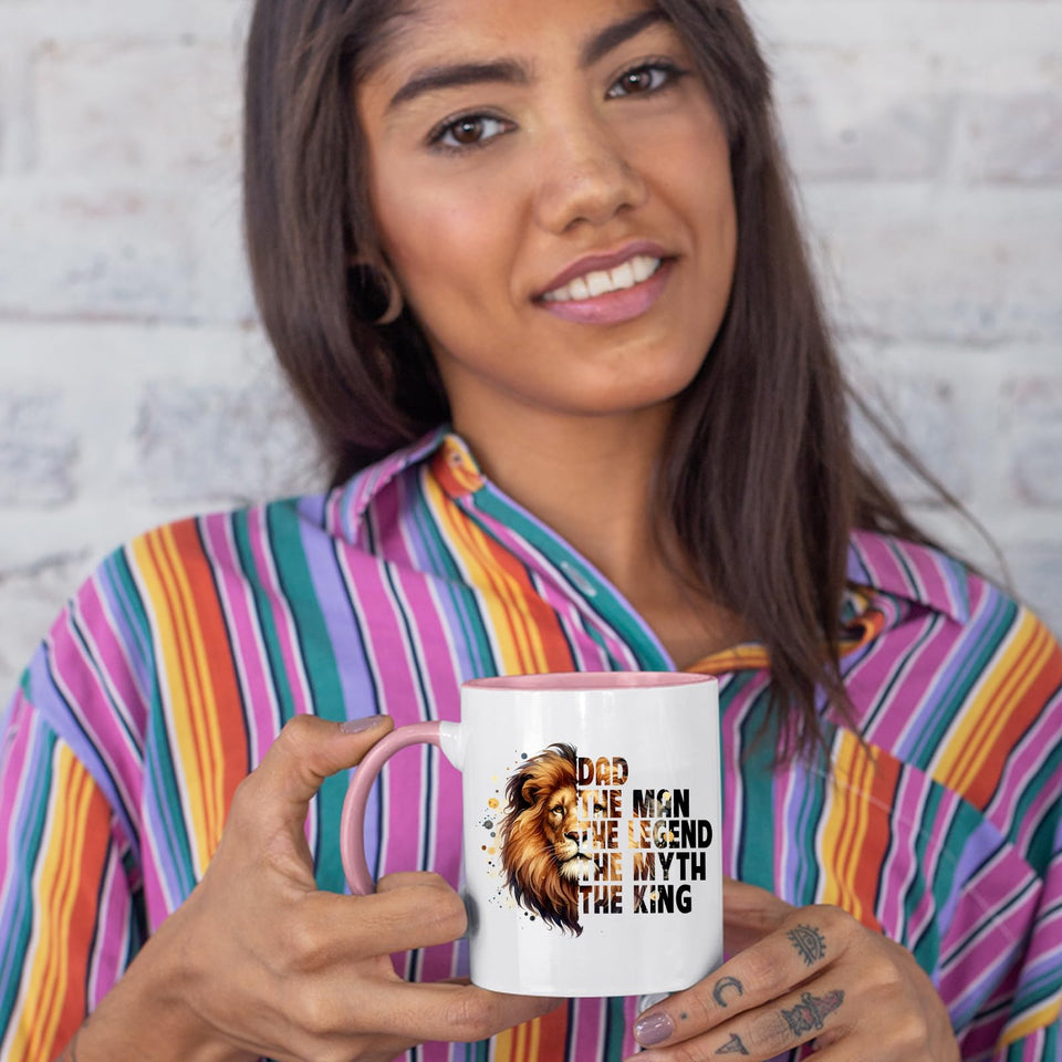 Woman in a striped shirt holding the Dad the King lion colour handle mug