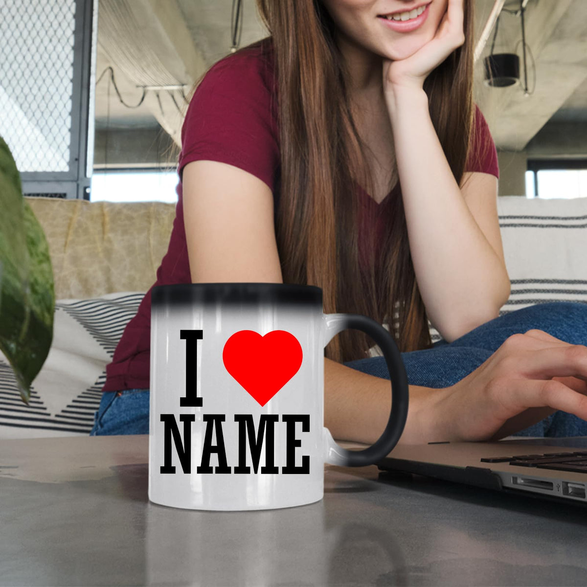 Woman at a laptop with an I love name colour changing mug