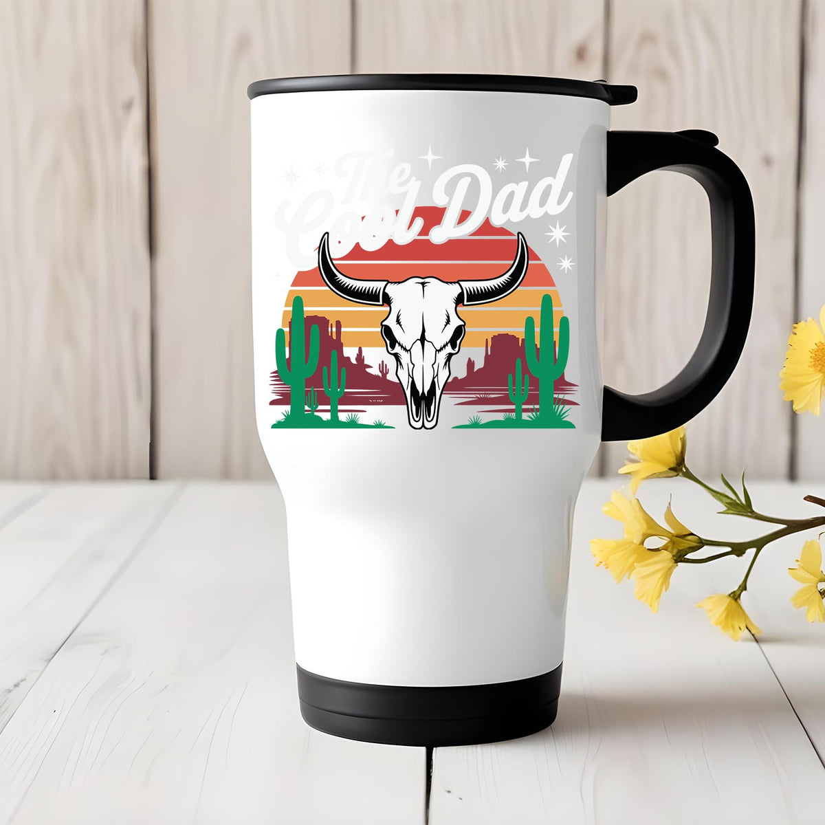 The Cool Dad bull skull travel mug on a white wooden table with yellow flowers