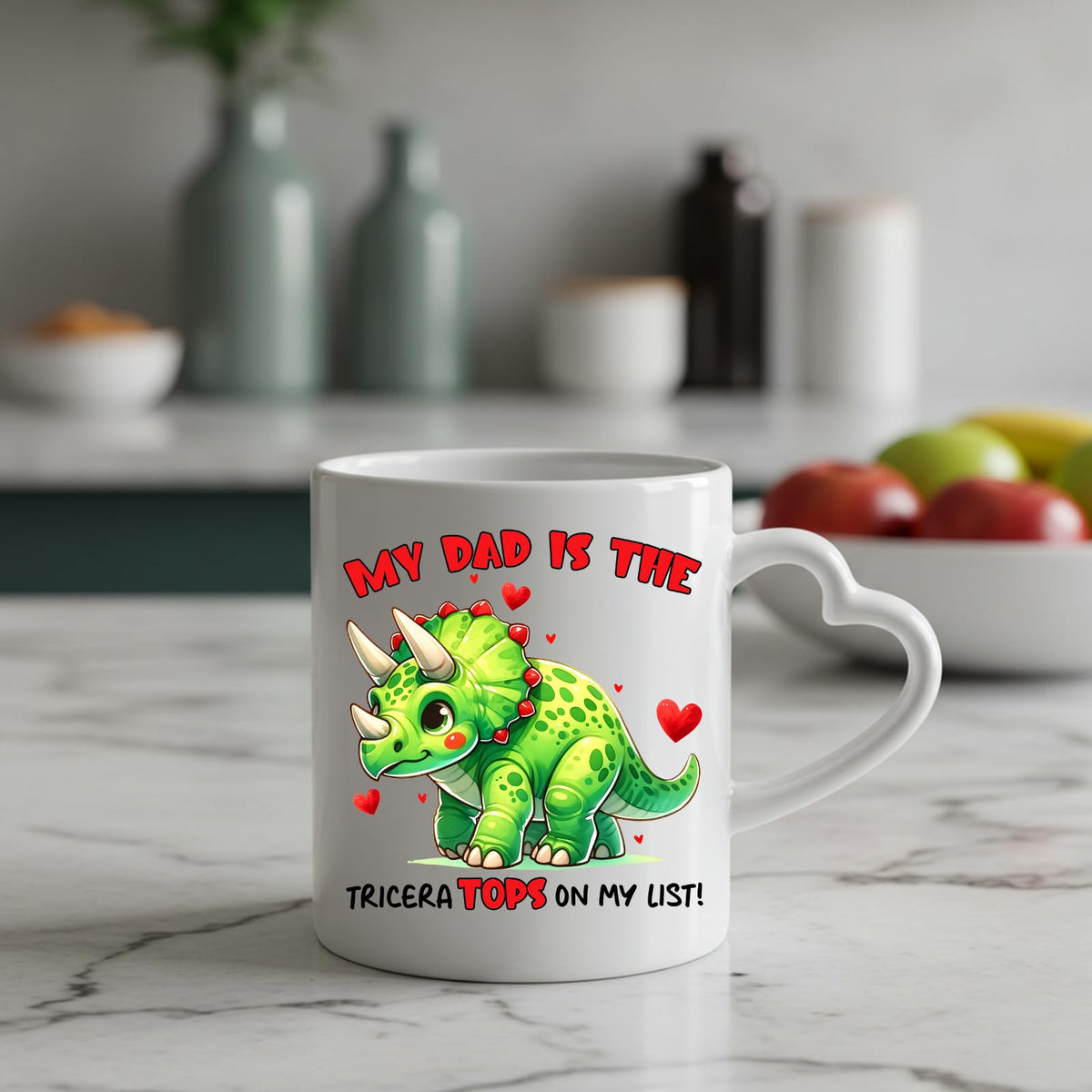 Triceratops dad heart-handle mug on a marble counter with fruit