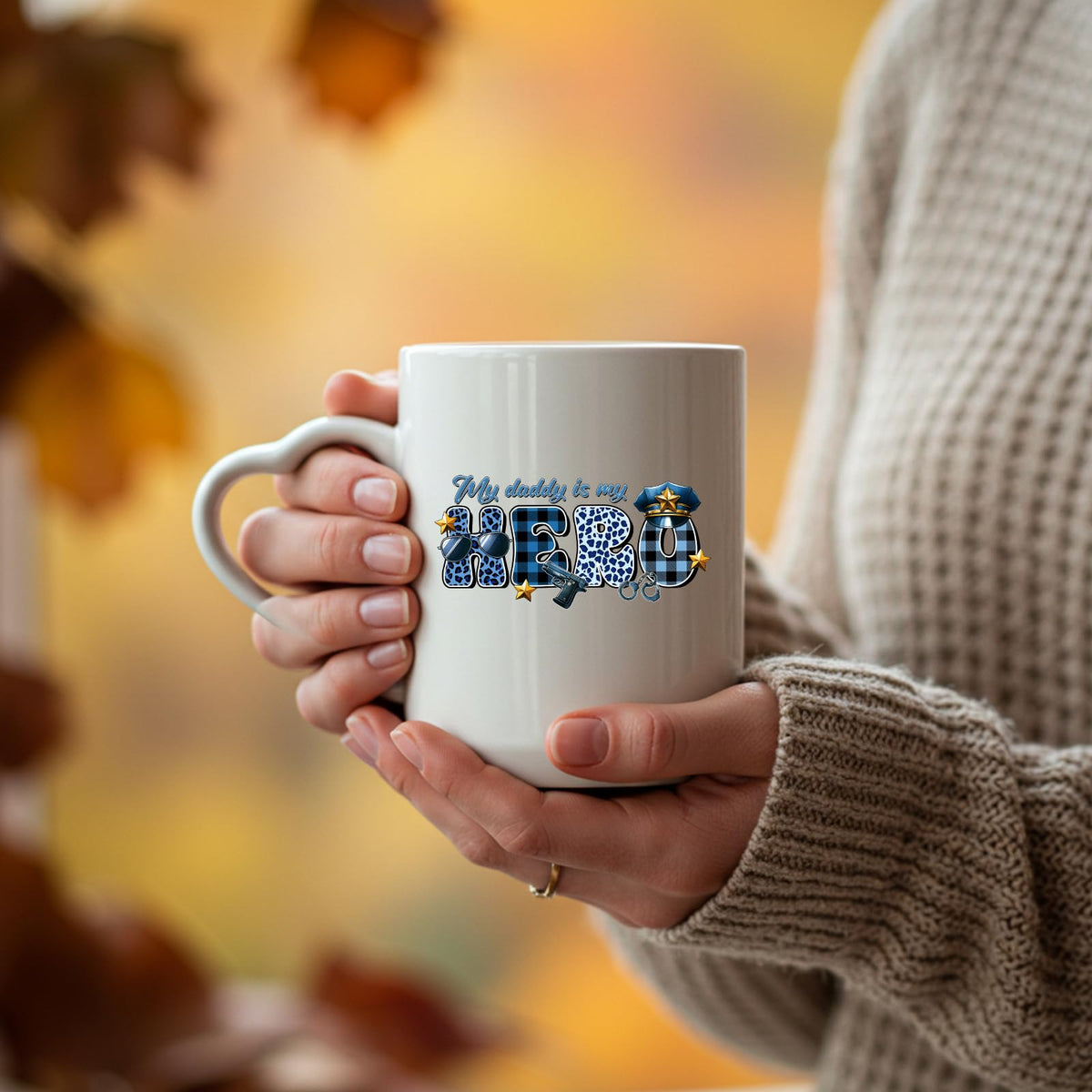 Hands holding the My Daddy Is My Hero police heart-handle mug