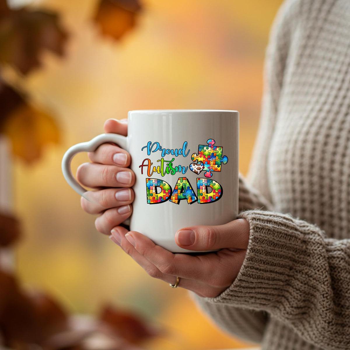 Hands holding the Proud Autism Dad heart-handle mug