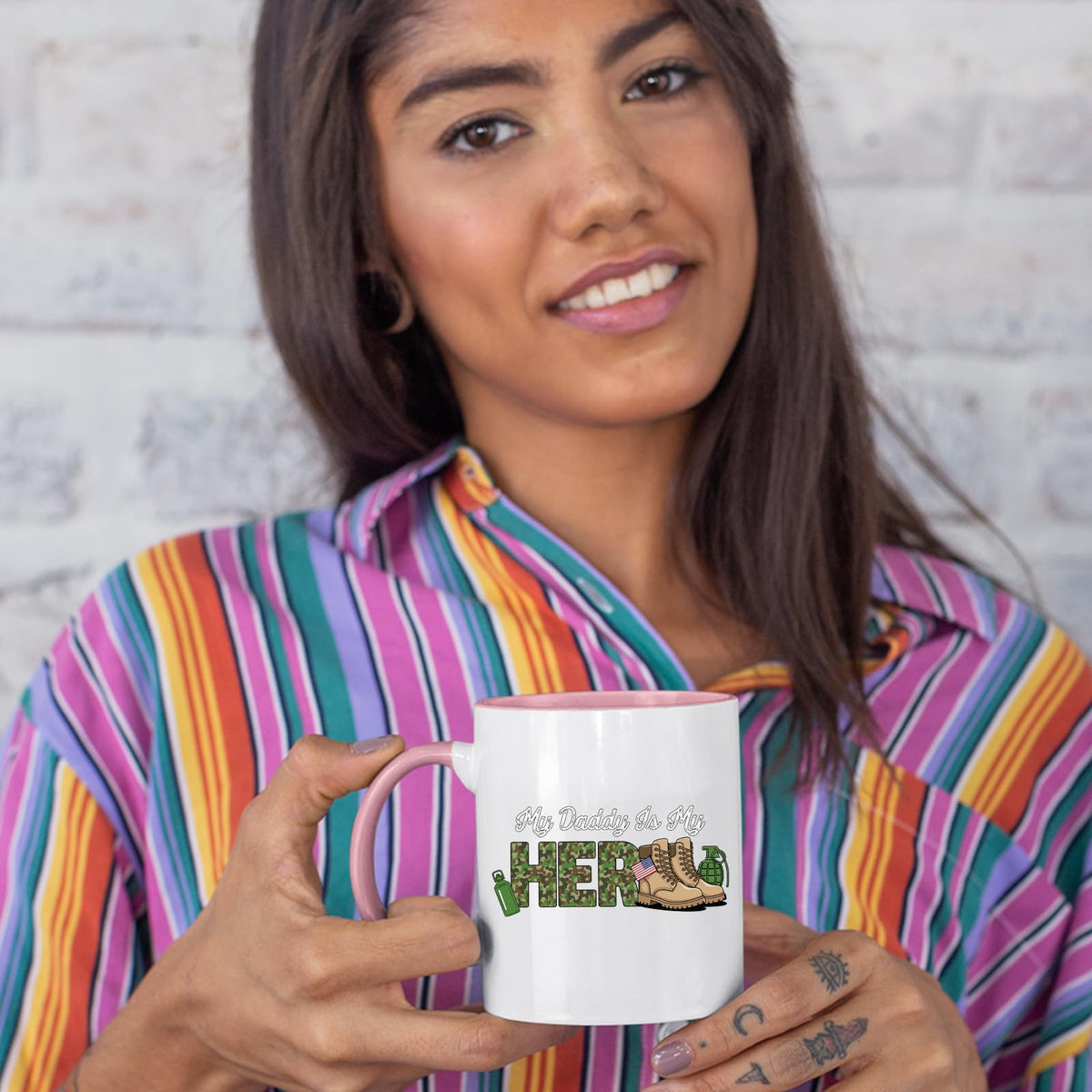 Woman in a striped shirt holding the My Daddy Is My Hero military colour handle mug
