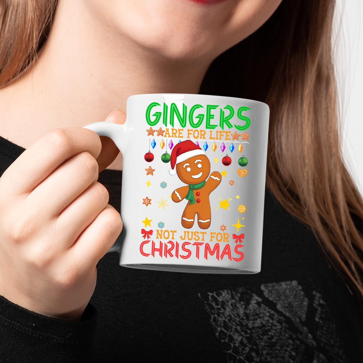 Woman in black holding a gingers are for life mug
