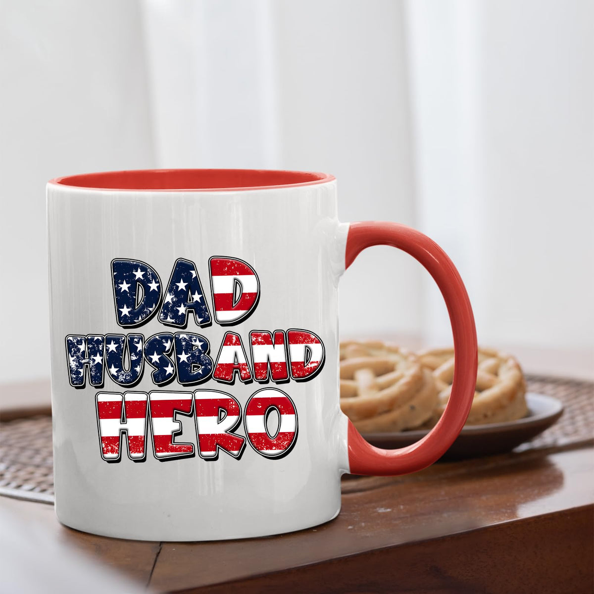 Dad Husband Hero mug with a red handle beside biscuits