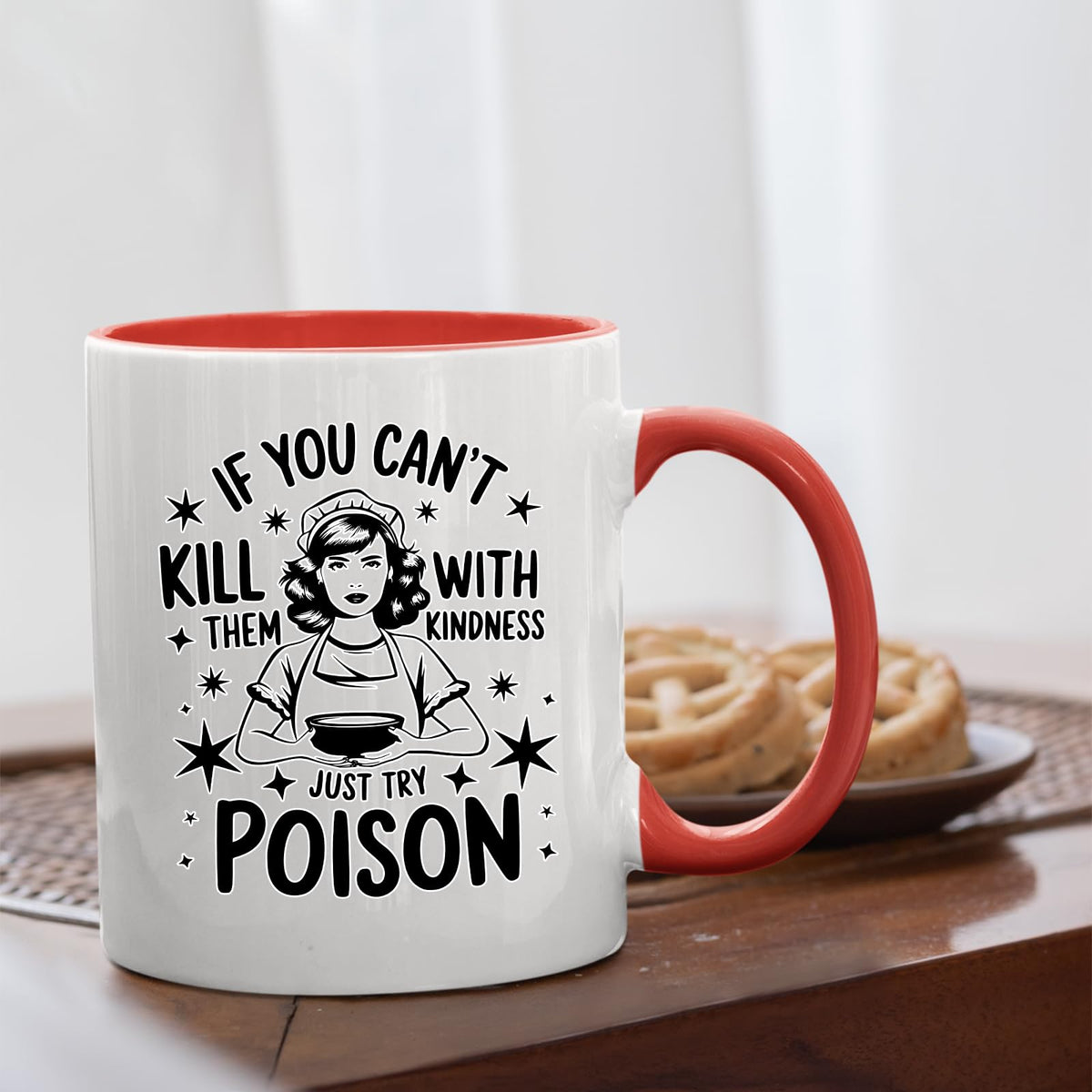 Just Try Poison mug with a red handle beside biscuits