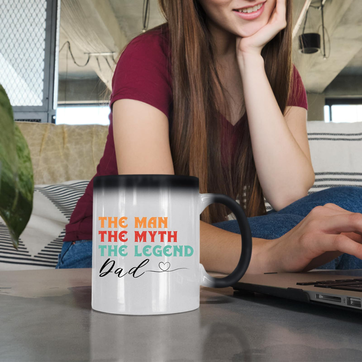 Woman at a laptop with the The Man the Myth Dad colour changing mug