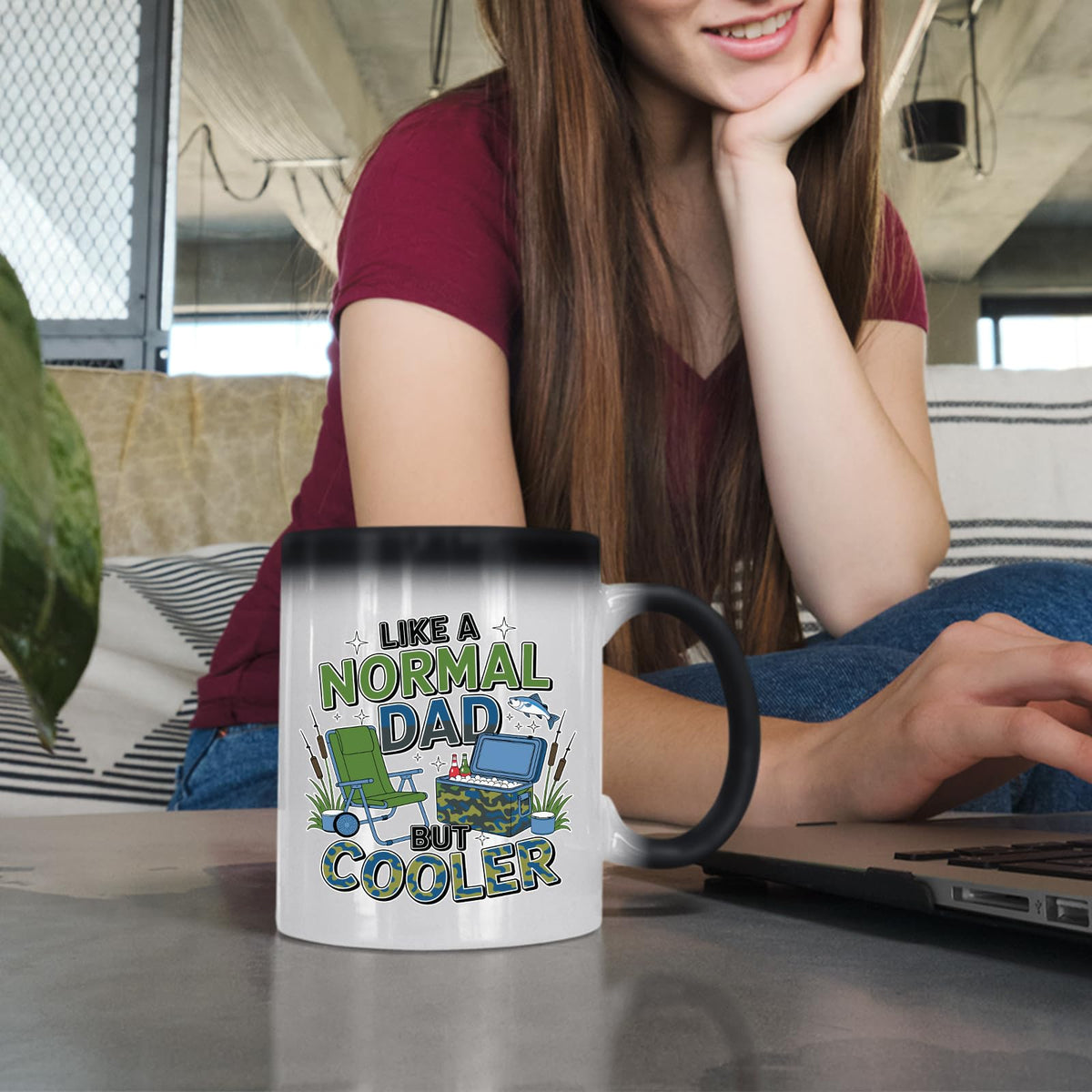 Woman at a laptop with the Like a Normal Dad But Cooler colour changing mug