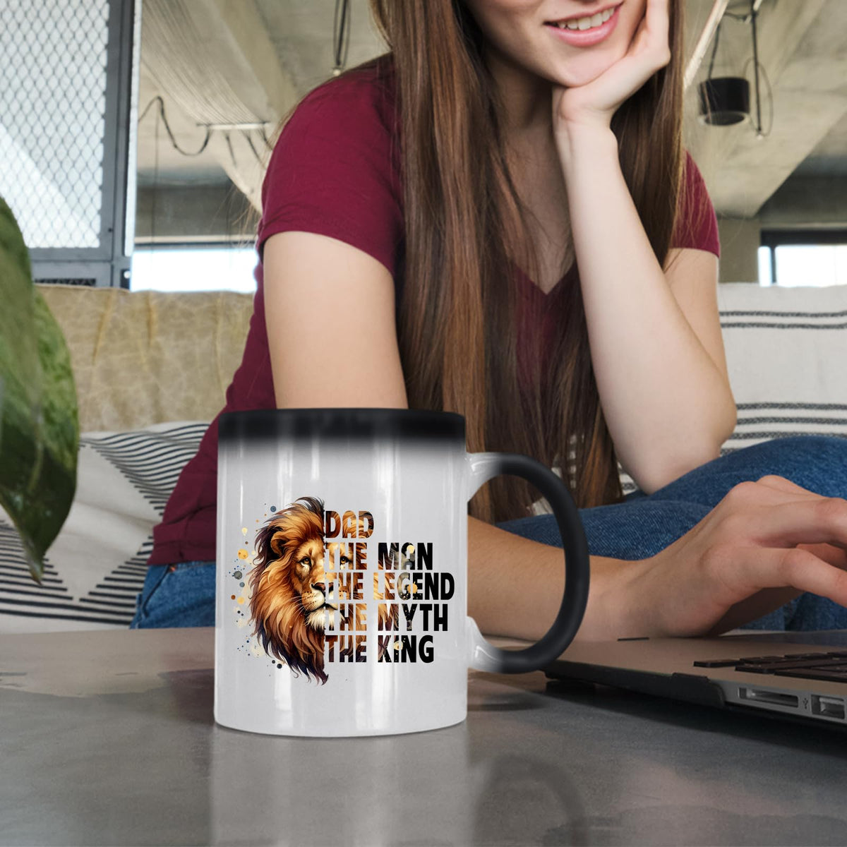 Woman at a laptop with the Dad the King lion colour changing mug