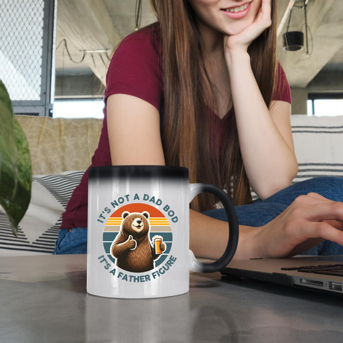Woman at a laptop with the Dad Bod bear colour changing mug