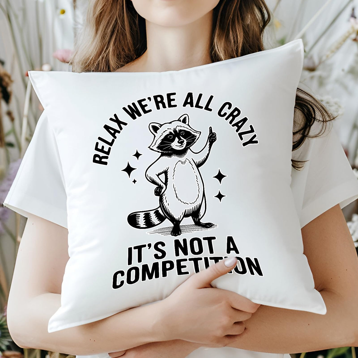 Woman hugging the Relax We’re All Crazy raccoon cushion