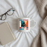 Like Father Like Daughter heart-handle mug on a bed beside glasses and a book
