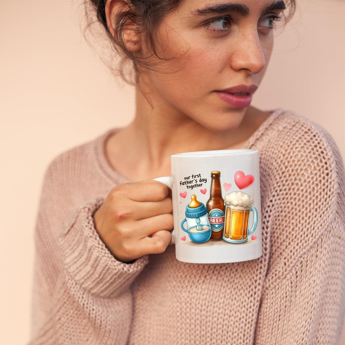 Woman in a pink jumper holding the First Father’s Day hearts mug