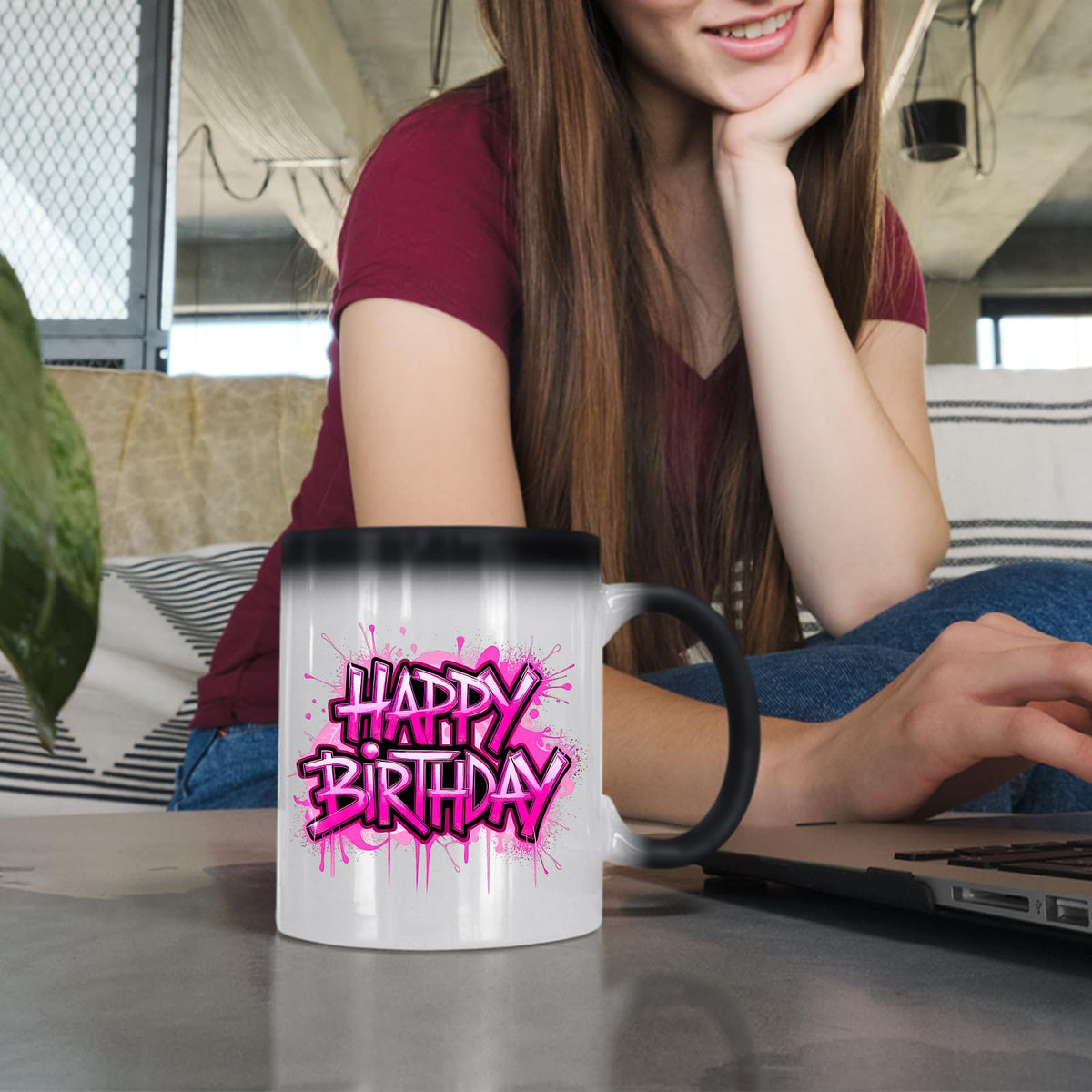 Woman at a laptop with the Happy Birthday pink drip colour changing mug