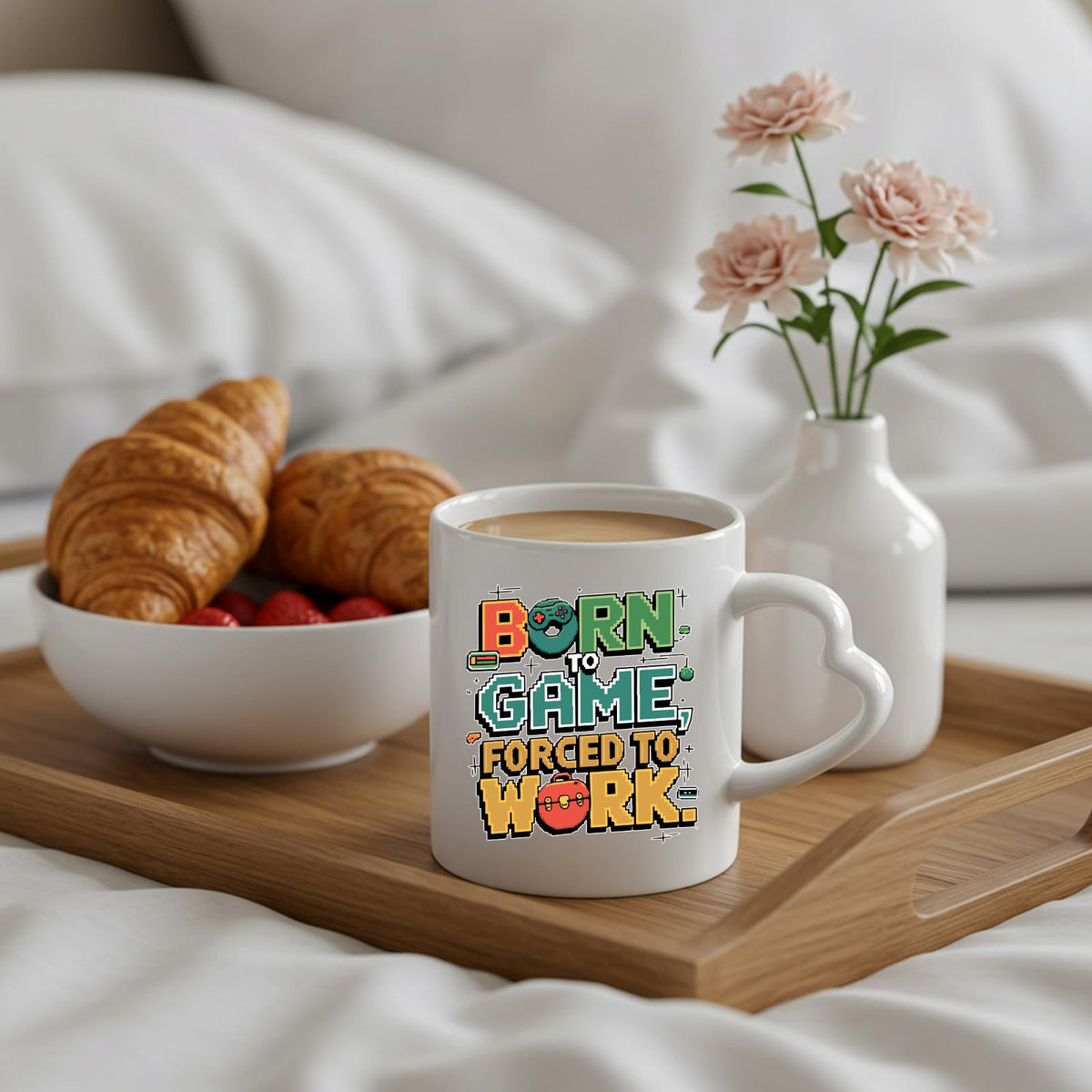 Born to Game heart-handle mug on a breakfast tray with croissants and flowers