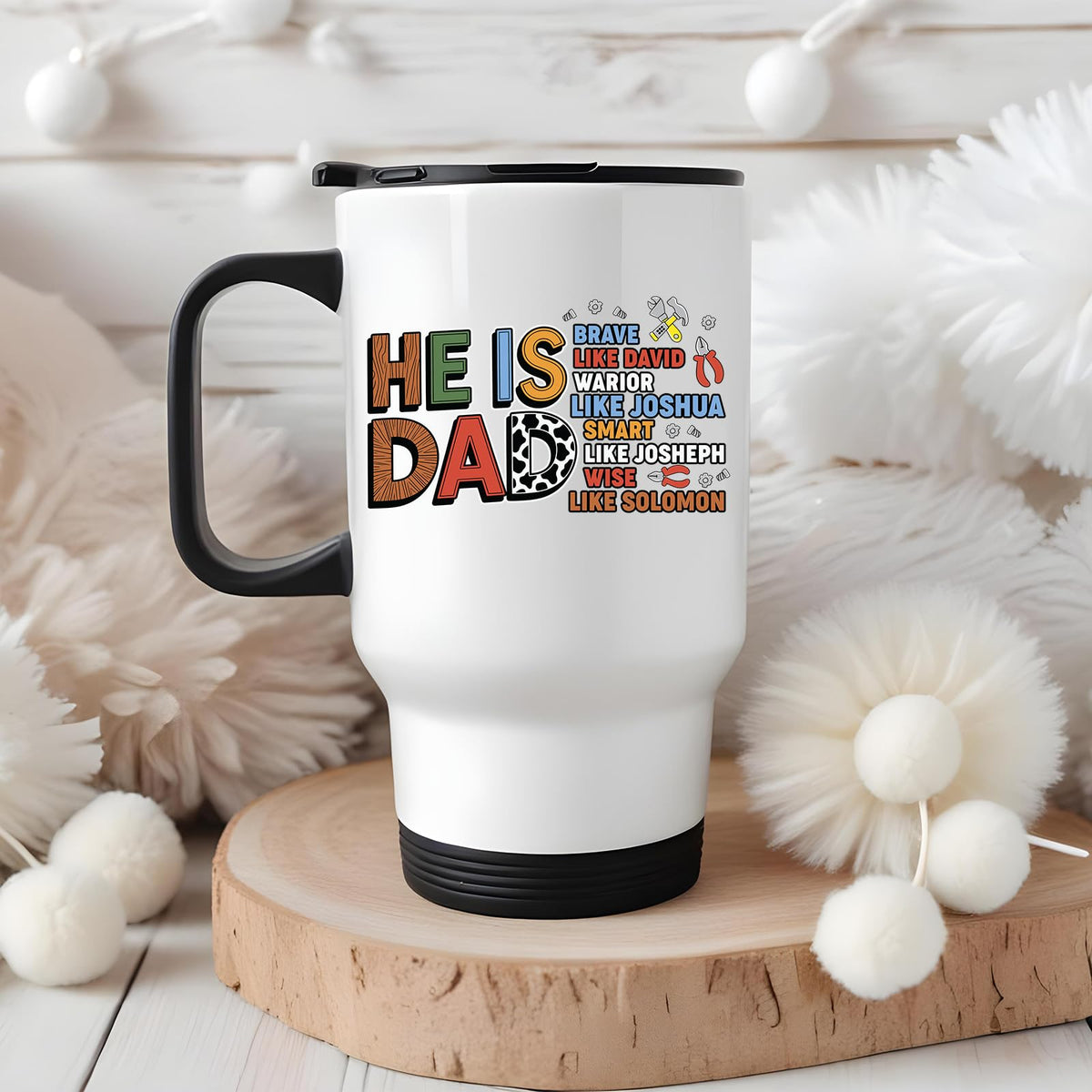 Travel mug with the He Is Dad Bible verse design in a cosy winter setting