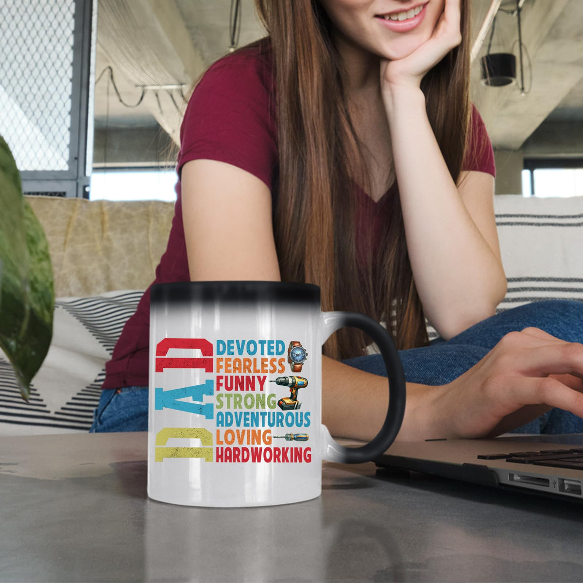 Woman at a laptop with the DAD Devoted colour changing mug