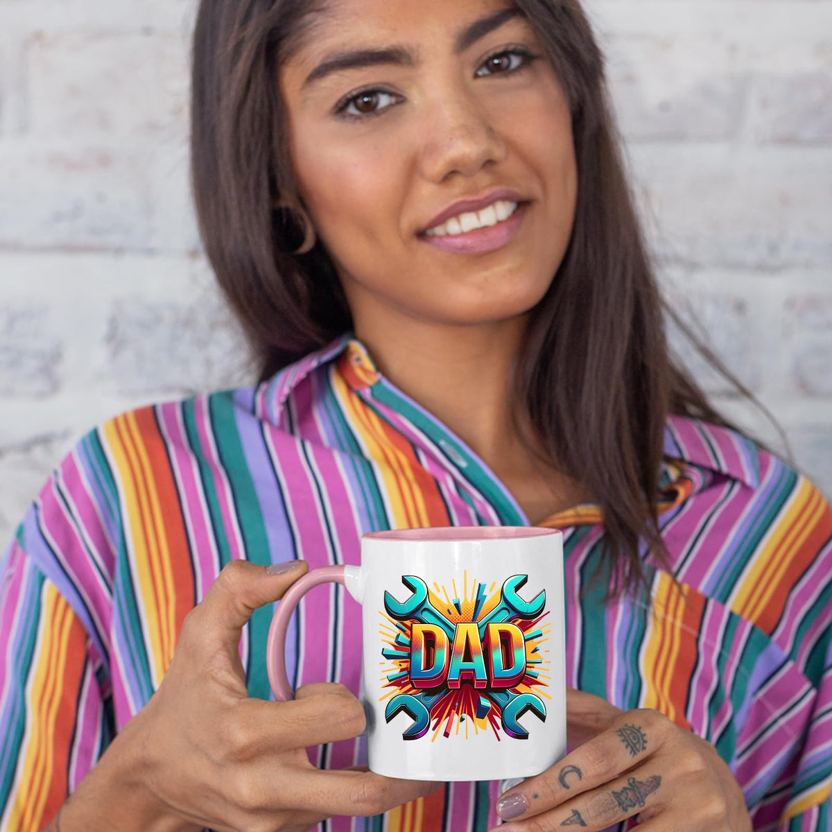 Woman in a striped shirt holding the DAD spanners colour handle mug