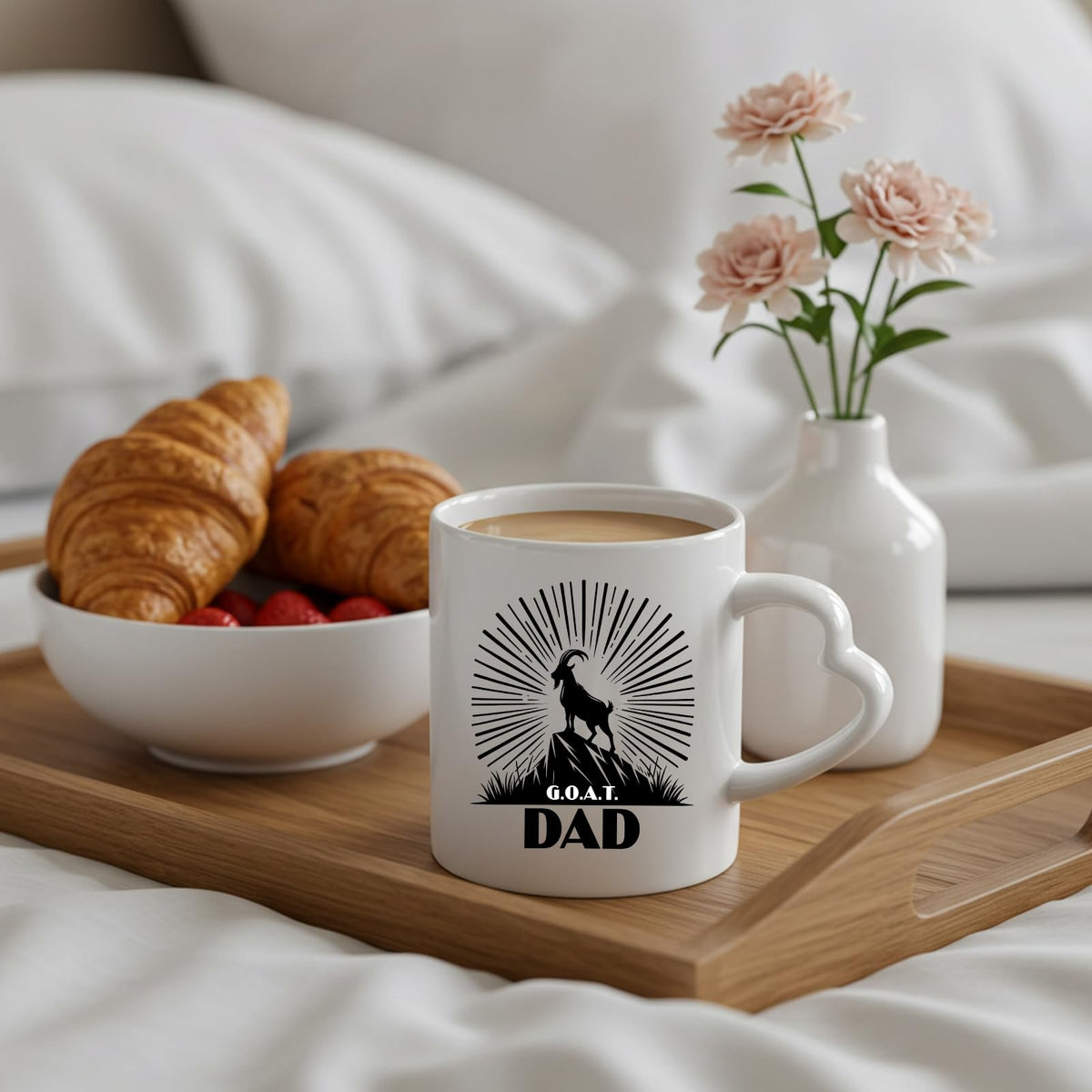GOAT Dad heart-handle mug on a breakfast tray with croissants and flowers