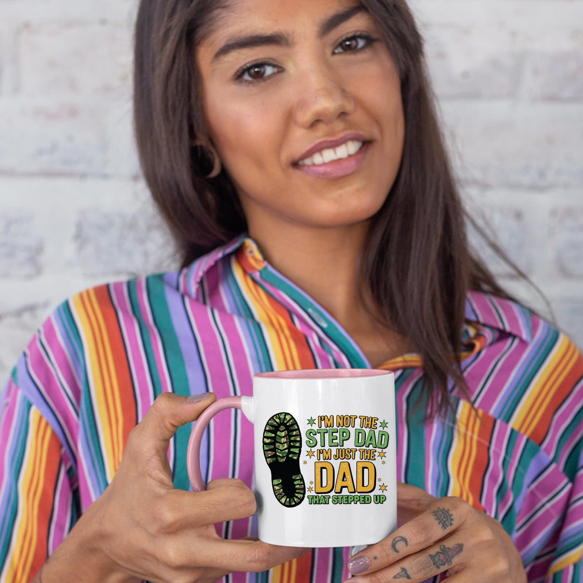 Woman in a striped shirt holding the Dad That Stepped Up colour handle mug