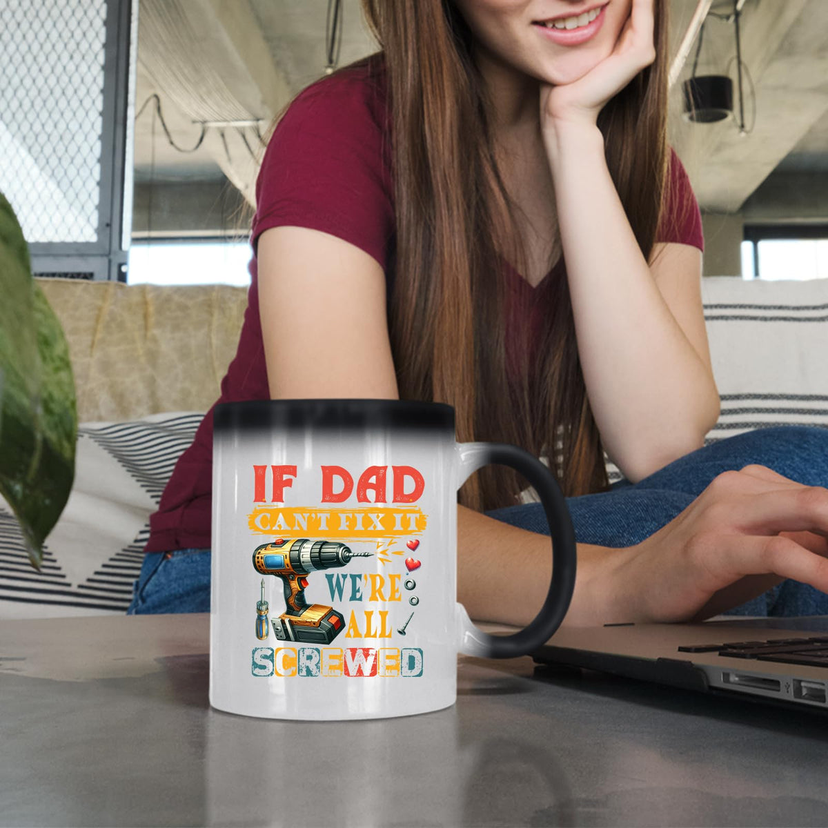 Woman at a laptop with the If Dad Can’t Fix It colour changing mug