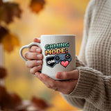 Hands holding the Gaming Mode On heart-handle mug