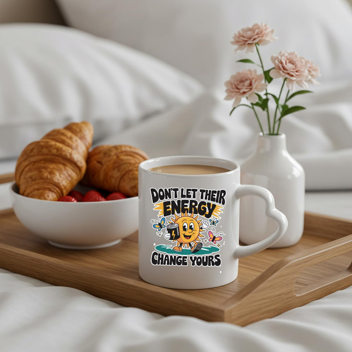 Positive Vibes sun heart-handle mug on a breakfast tray with croissants and flowers