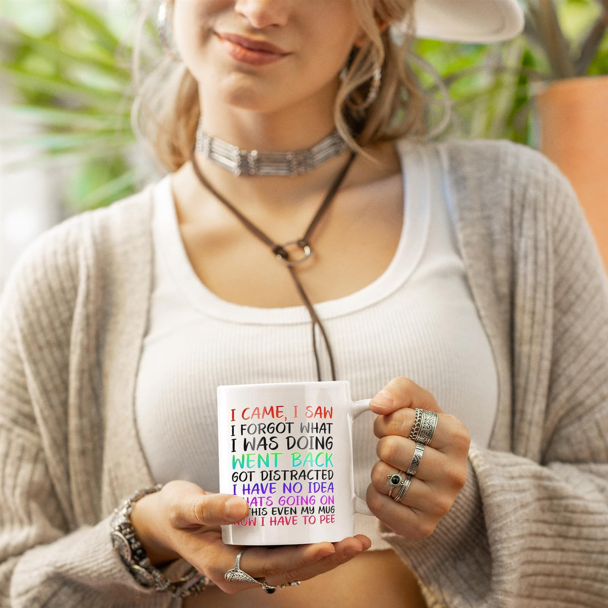 Woman in a cardigan holding the I Came I Saw I Forgot mug