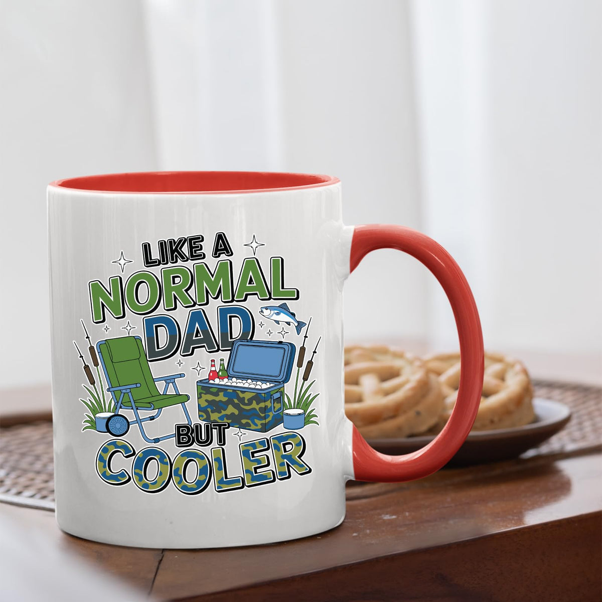 Like a Normal Dad But Cooler mug with a red handle beside biscuits