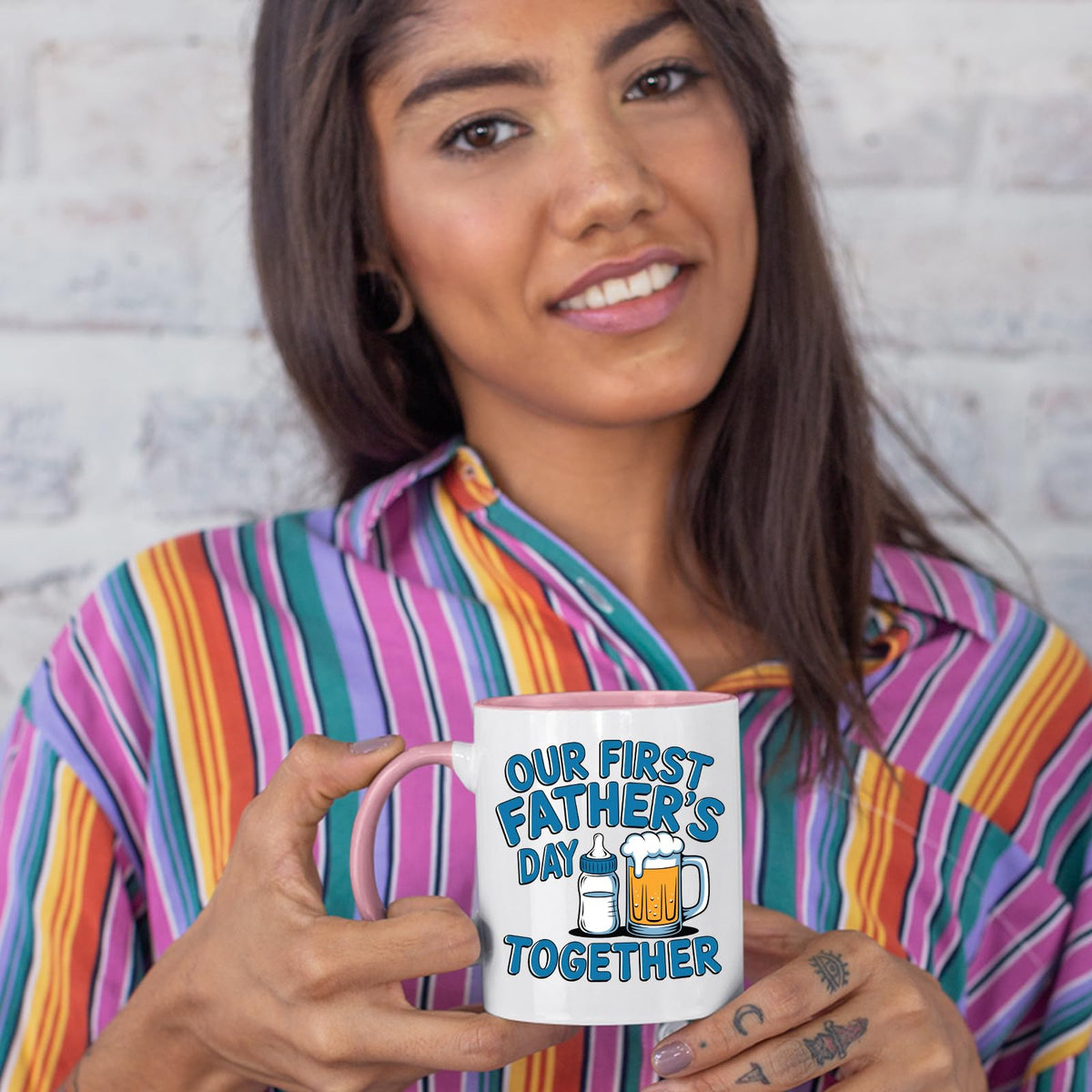 Woman in a striped shirt holding the First Father’s Day bottle and beer colour handle mug