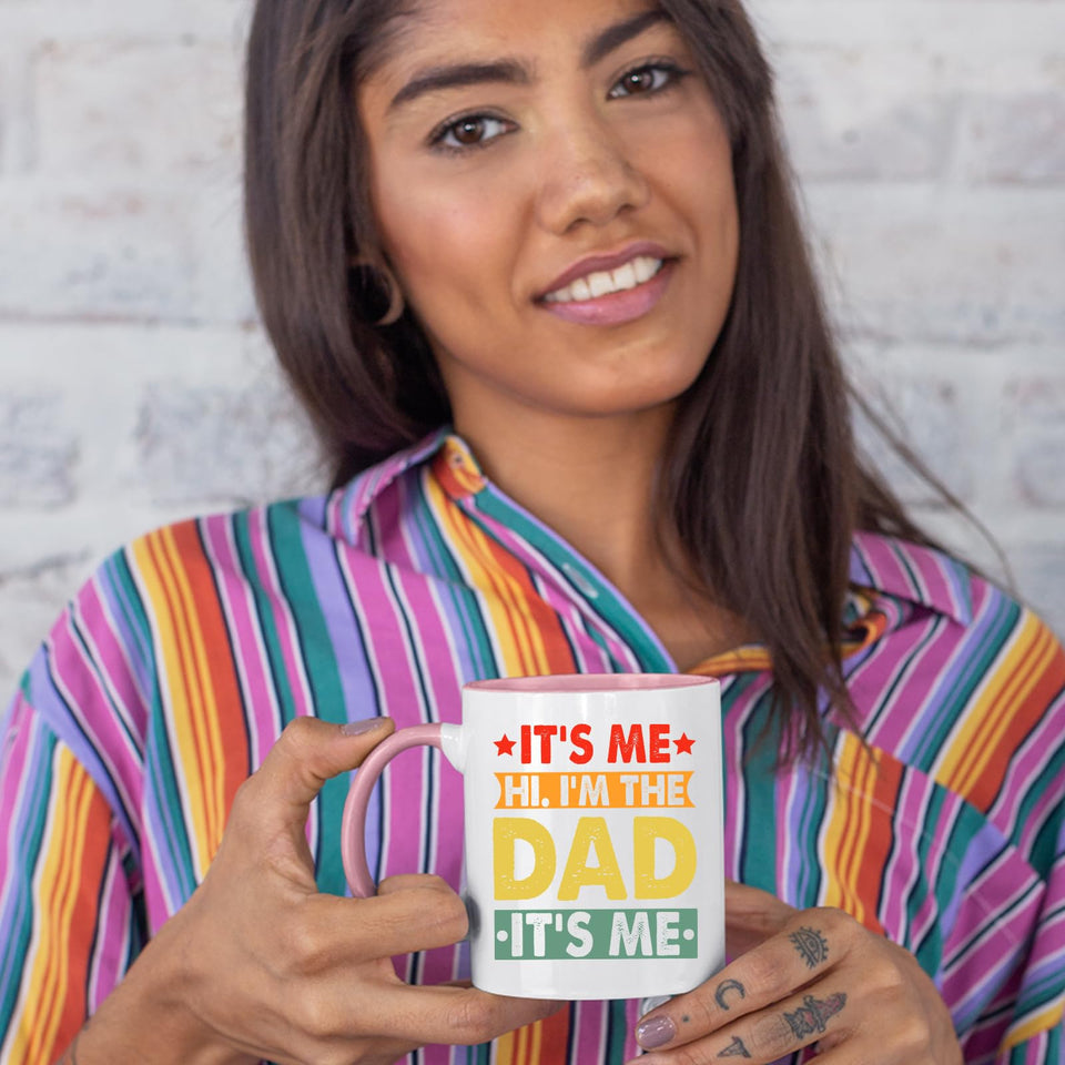 Woman in a striped shirt holding the It’s Me Hi I’m the Dad colour handle mug