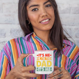 Woman in a striped shirt holding the It’s Me Hi I’m the Dad colour handle mug
