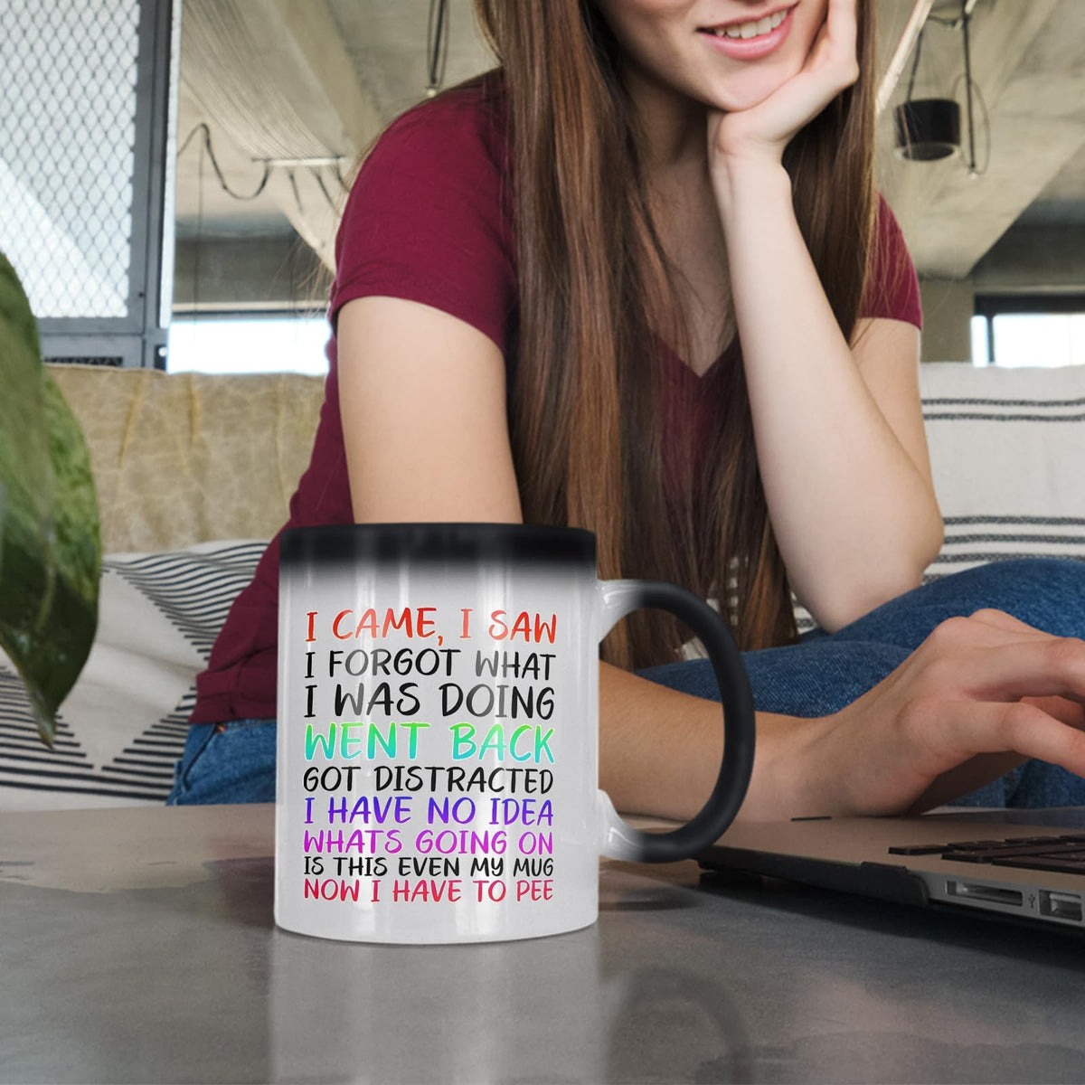Woman at a laptop with the I Came I Saw I Forgot colour changing mug