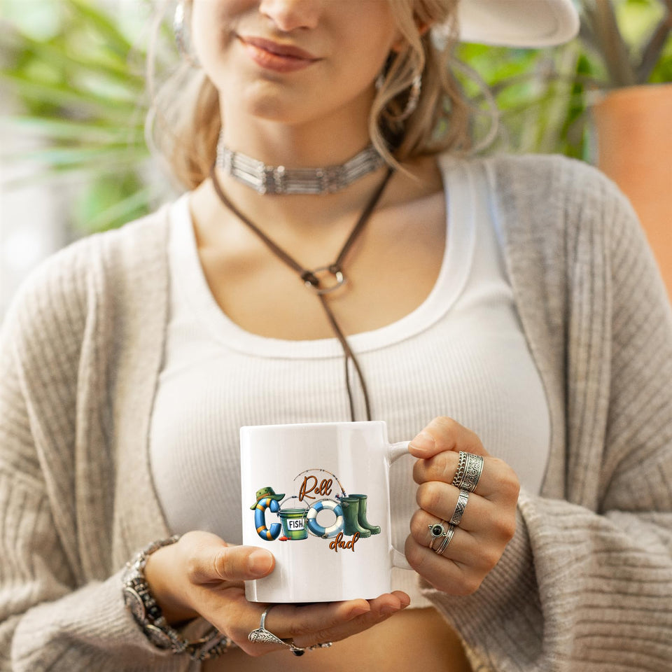 Woman in a cardigan holding the Reel Cool Dad mug