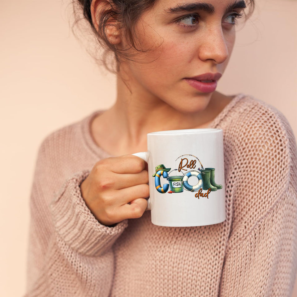 Woman in a pink jumper holding the Reel Cool Dad mug