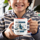 Smiling child holding the Like Father Like Son mug with a red handle