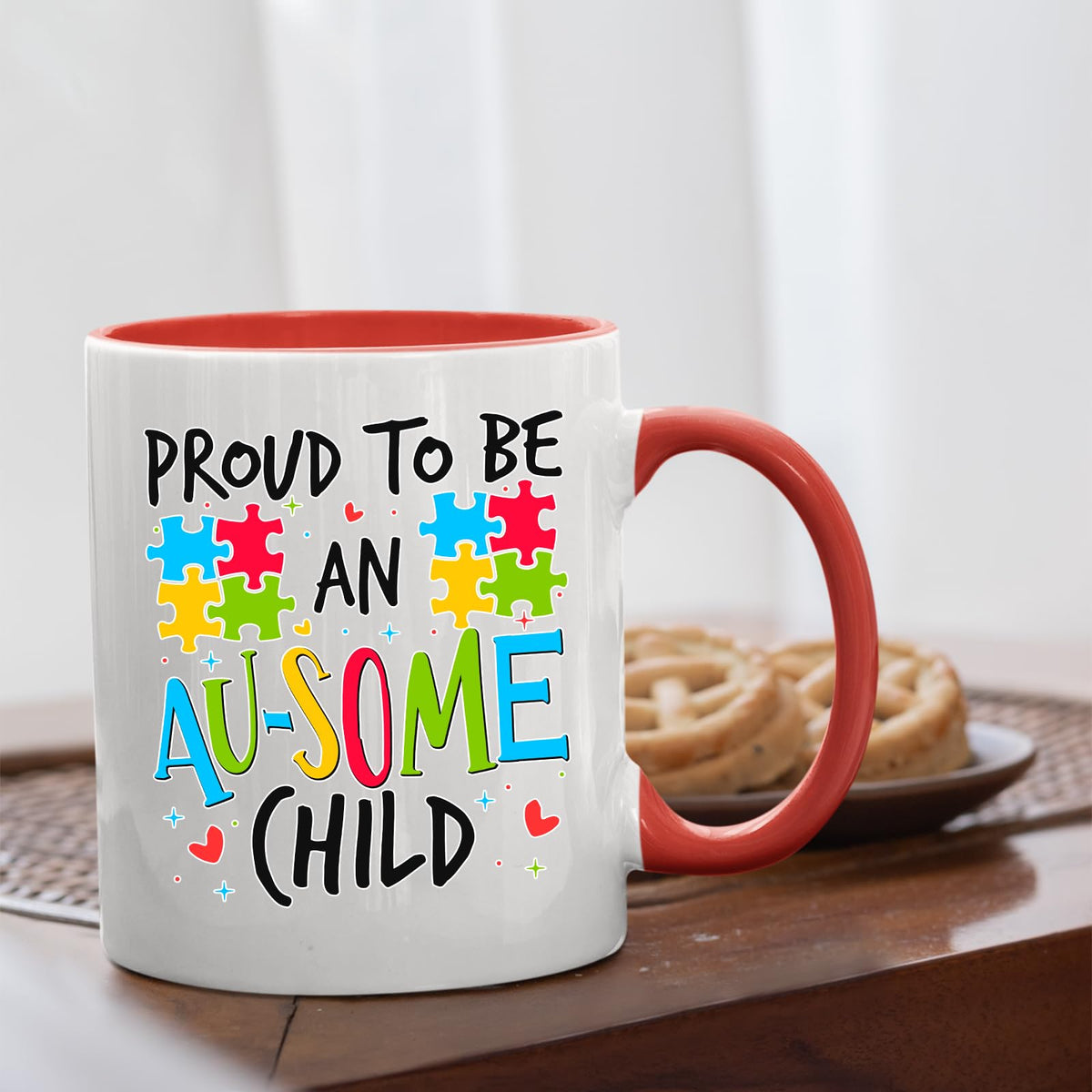Proud to Be an Au-Some Child mug with a red handle beside biscuits