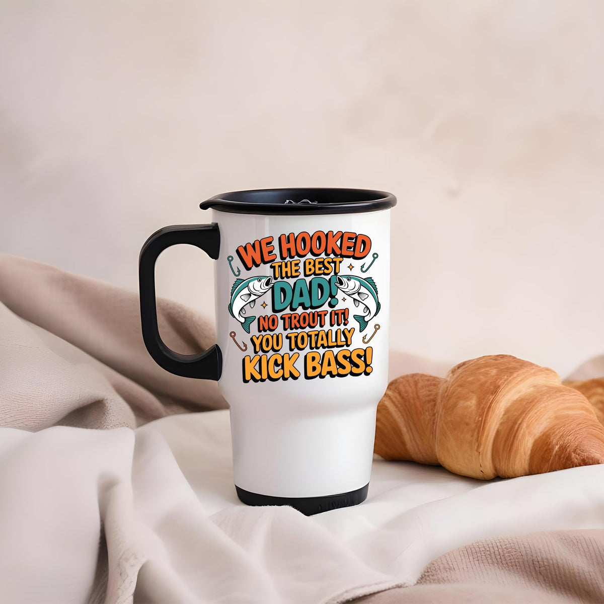 We Hooked the Best Dad travel mug on a soft blanket beside a croissant