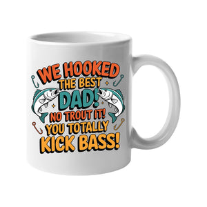 White mug with two leaping fish and “We hooked the best Dad! No trout about it! You totally kick bass!”