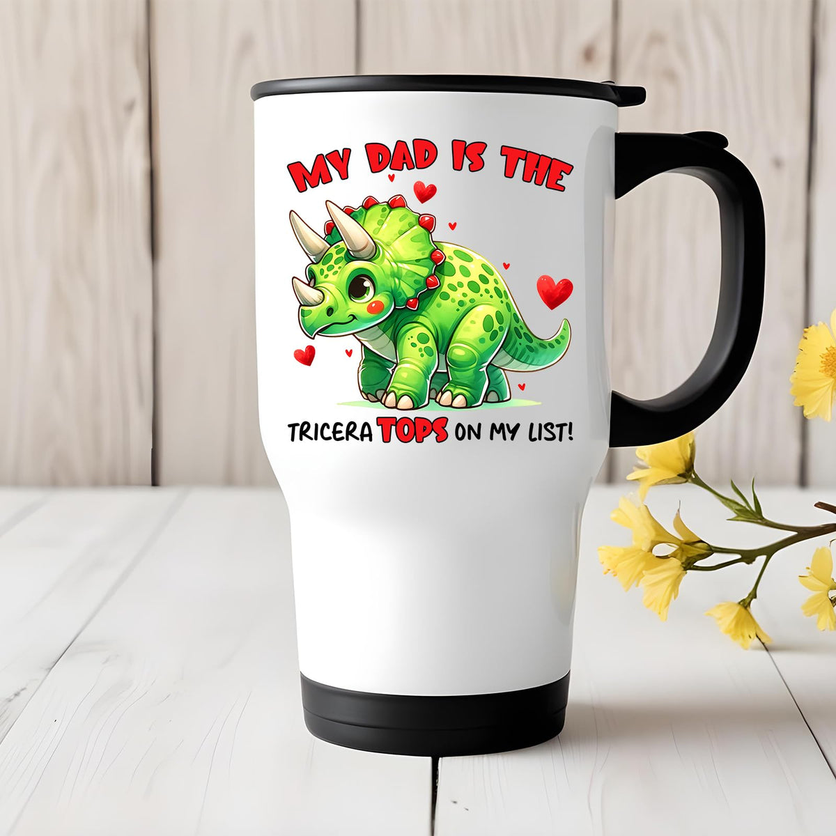 Triceratops dad travel mug on a white wooden table with yellow flowers